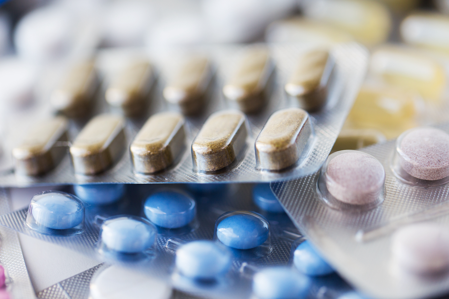 different pills and capsules of drugs